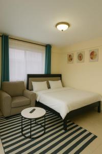 Ένα ή περισσότερα κρεβάτια σε δωμάτιο στο Majestic Studio Kikuyu