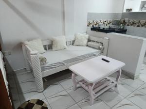 a living room with a couch and a table at Watamu Plaza Studio 3 in Watamu +2 photos