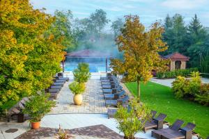 a row of benches in a garden with a gazebo at Mesés Shiraz Hotel Superior-Adults only in Egerszalók