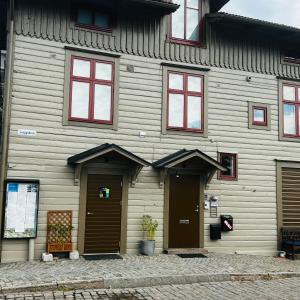 a wooden building with two doors and windows at Stekhuset B&B in Kalmar