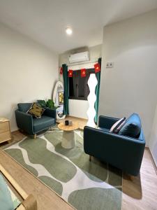 a living room with two couches and a table at DK2 Homestay in Hanoi