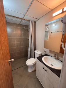 a bathroom with a toilet and a sink at Nest Quest Amoret Homes Resort style 1Bhk Adora De Goa in Dabolim