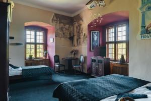 a bedroom with two beds and a desk and windows at Zamek Czocha in Leśna +235 photos