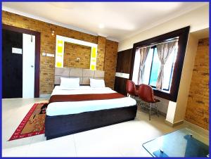 a bedroom with a large bed and a window at HOTEL SAI & SAND PIPER Near Jagannath Temple - Restaurant and Parking Facilities - Fully Air Conditioning Hotel - A Top Rated Hotel in Gaya