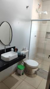 a bathroom with a toilet and a sink and a mirror at Casa Viva Bonito in Bonito +41 photos
