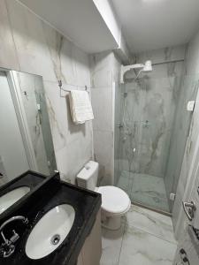 a bathroom with a sink and a shower and a toilet at Flat Novo no Centro de Porto de Galinhas in Porto De Galinhas
