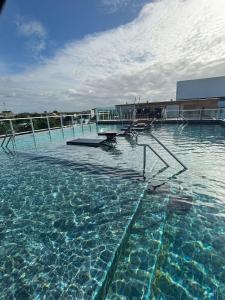 a large pool of water with stairs in it at Flat Novo no Centro de Porto de Galinhas in Porto De Galinhas