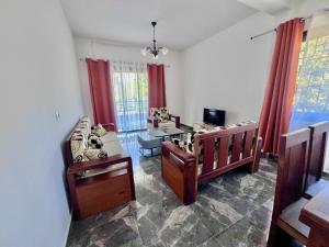 a living room with two beds and a couch at Appart Nouvelle Ville Toamasina in Toamasina