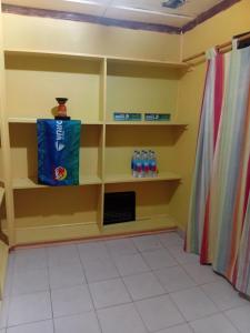 a room with shelves with water bottles on them at Loa House Homestay in Lautoka