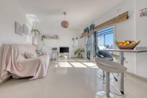 a living room with a table and a chair at The mermaid House- Playa Honda in Playa Honda