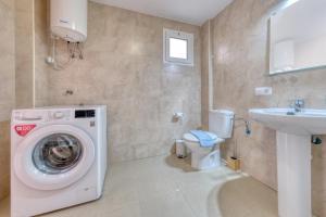 a bathroom with a washing machine and a sink at The mermaid House- Playa Honda in Playa Honda +21 photos