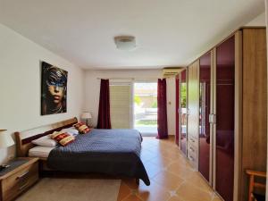 a bedroom with a bed with a face on the wall at Apartments Andrija in Kotor