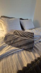 an unmade bed with two pillows on top of it at Studio at Tottinkatu in Savonlinna