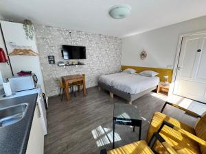 a hotel room with a bed and a living room at Appartement Villa Eva Rosa in Wijk aan Zee