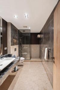 a bathroom with a sink and a shower at Helnan Hotel - Port Fouad in Port Said