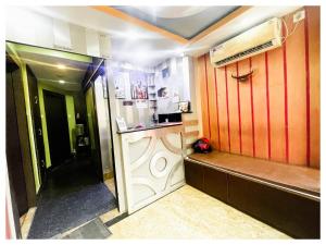 a room with a kitchen with red walls at Asmit আসমিত Kolkata Full AC Room in kolkata