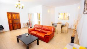 a living room with a couch and a table at Keur Maï in Dakar +2 photos
