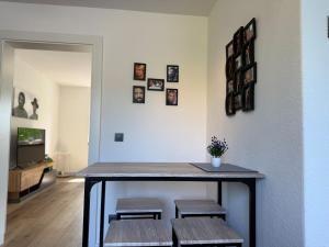 a room with a table with benches and pictures on the wall at Harz tranquility - Sauna & comfort in Thale