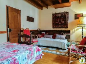 a bedroom with two beds and a table and chairs at Au village in Boutx