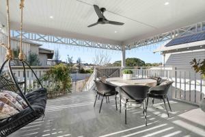 a patio with a table and chairs and a ceiling fan at The Milton Haven - Pet Friendly & Heated Pool in Milton