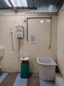 a bathroom with a toilet and a bath tub at Fantasy Stay Cameron Highlands in Kampung Kuala Terla