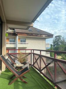 a balcony with two chairs and a table on a building at La Versoie in Thonon-les-Bains +7 photos