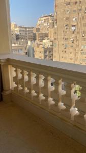 a white balcony with a view of a city at H&d abrrtment hotel 5 in Cairo