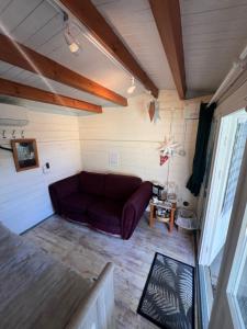 a living room with a purple couch in a room at 29 Park Avenue , Shoreham-by-Sea , Cozy Cabin in Shoreham-by-Sea