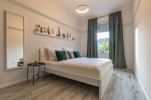 a bedroom with a large bed with a window at business or holiday in Wiesbaden