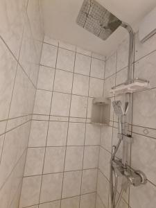 a white bathroom with a shower with a shower at Pause Nature N in La Calamine +12 photos