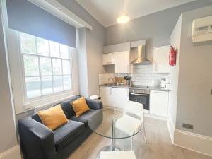 a living room with a couch and a table at Beautiful studio - Whiteladies road in Bristol
