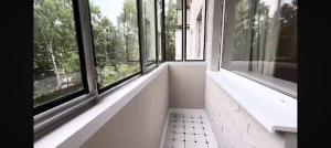 an empty room with windows and a tiled floor at Квартира в центре in Mykolaiv