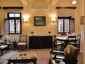 a living room with a couch and a table and chairs at Mundoota House in Jaipur