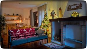 a living room with a christmas tree and a fireplace at Villa Meledrio in Dimaro