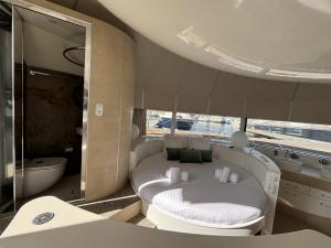 a white room with a tub and a bed in a boat at ANTHENEA Trebeurden in Trébeurden +27 photos