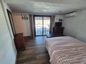 a bedroom with a bed and a sliding glass door at Welcome to your rural retreat, Casita Canaria III in La Sabinita