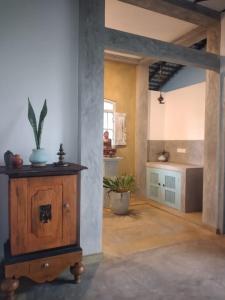 a living room with a wooden cabinet in a room at Inura Villa in Ambalangoda