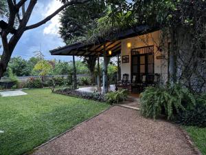 a garden view of a house with a patio at Inura Villa in Ambalangoda