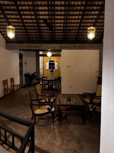 a room with chairs and a table and a television at Inura Villa in Ambalangoda +30 photos