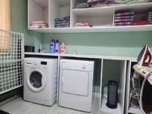 a laundry room with a washer and a washing machine at Cheap & Good by Topo in Tirana