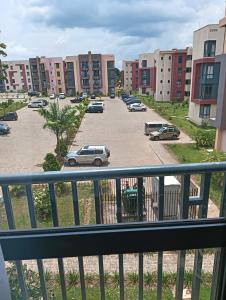 a view of a parking lot from a balcony at Cosy and Elegant apartment in Ntabwe