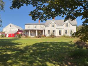 a large white house with a red barn at My Valhalla Farm-Room Rentals in Oakland