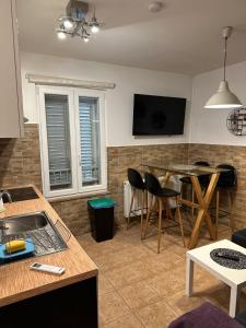 a kitchen and living room with a table and chairs at Apartment Nina in Biograd na Moru