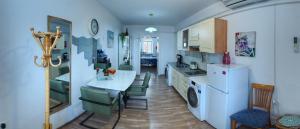 a kitchen with a table and chairs in a room at Apartma MB-Center in Maribor