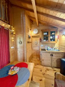a small kitchen with a table in a cabin at La Cabane à l'Orée des Bornes in Évires +51 photos