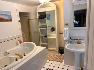 a white bathroom with a tub and a sink at My Valhalla Farm-Room Rentals in Oakland +25 photos