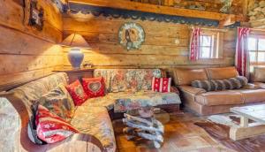 a living room with a couch and a table at Chalet spacieux à Saint-Nicolas-la-Chapelle avec cheminée in Saint-Nicolas-la-Chapelle