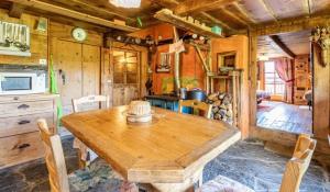 a dining room with a wooden table in a kitchen at Chalet spacieux à Saint-Nicolas-la-Chapelle avec cheminée in Saint-Nicolas-la-Chapelle