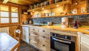 a kitchen with wooden cabinets and a stove top oven at Chalet spacieux à Saint-Nicolas-la-Chapelle avec cheminée in Saint-Nicolas-la-Chapelle +46 photos