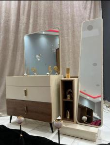 a dresser with a mirror on top of it at Alraei 1MH Hotel in Größing